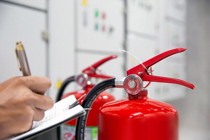 Man inspecting fire extinguishers